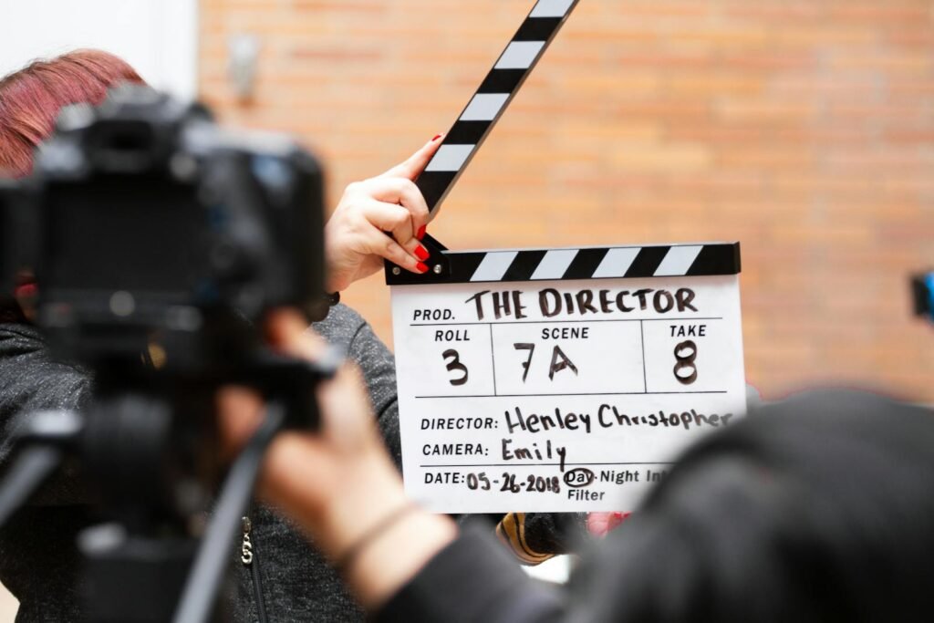 Tomás González Sánchez Madrid Close-up of film clapperboard in action with camera filming a take on set.